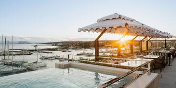 a pool with a view of a marina and boats in the background