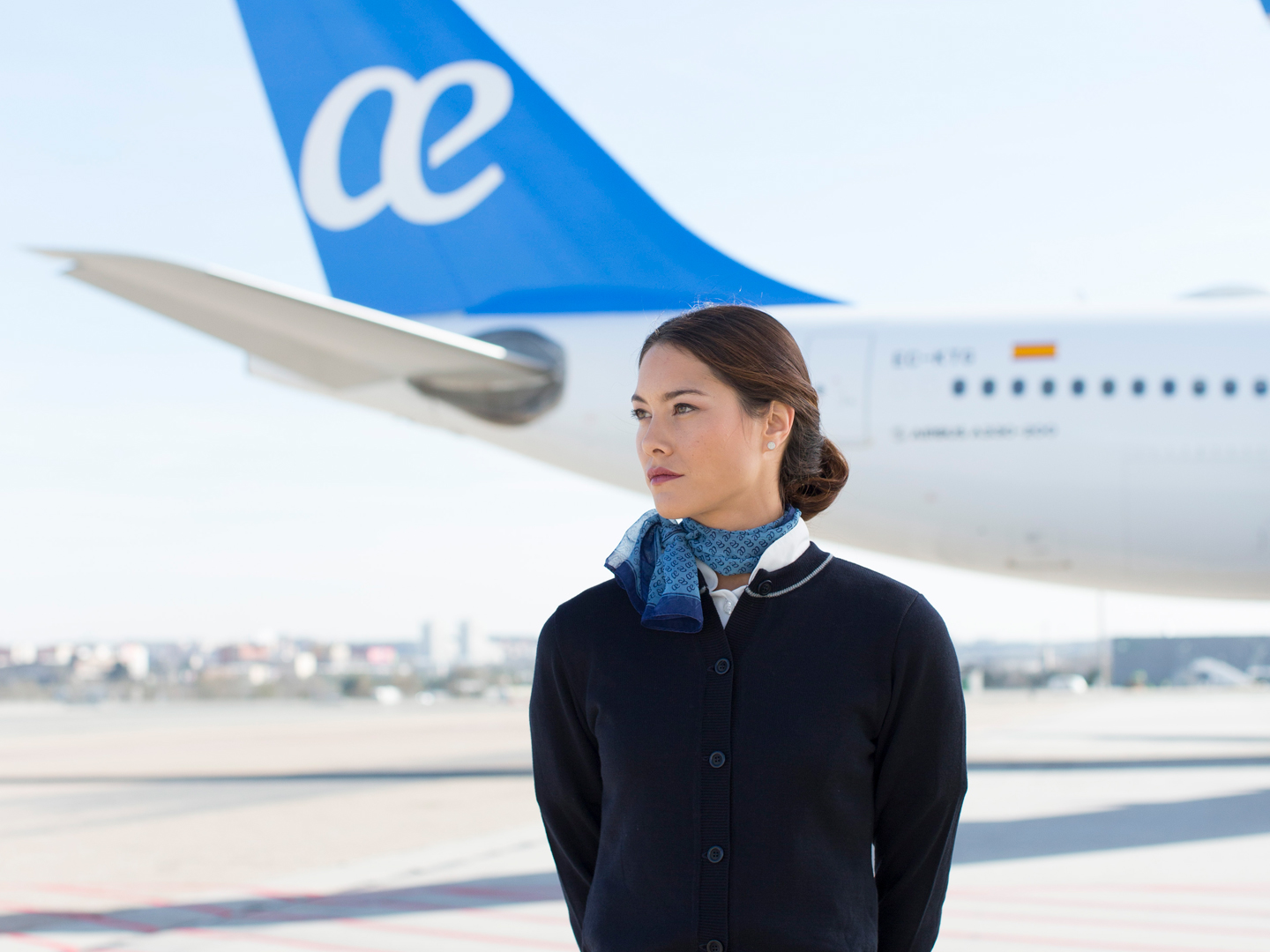 a woman standing in front of an airplane