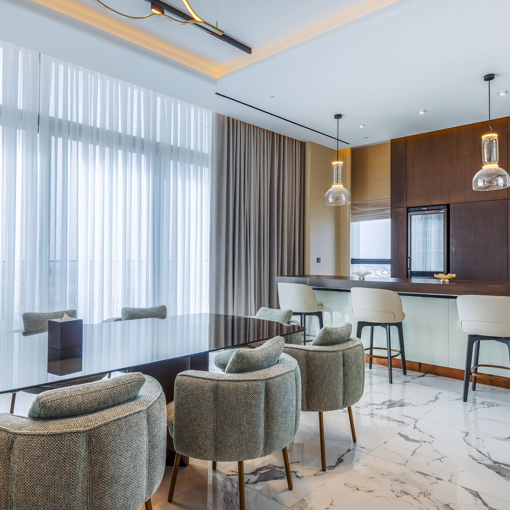 Luxury modern dining room with bar, dark table, stylish chairs, and city view.
