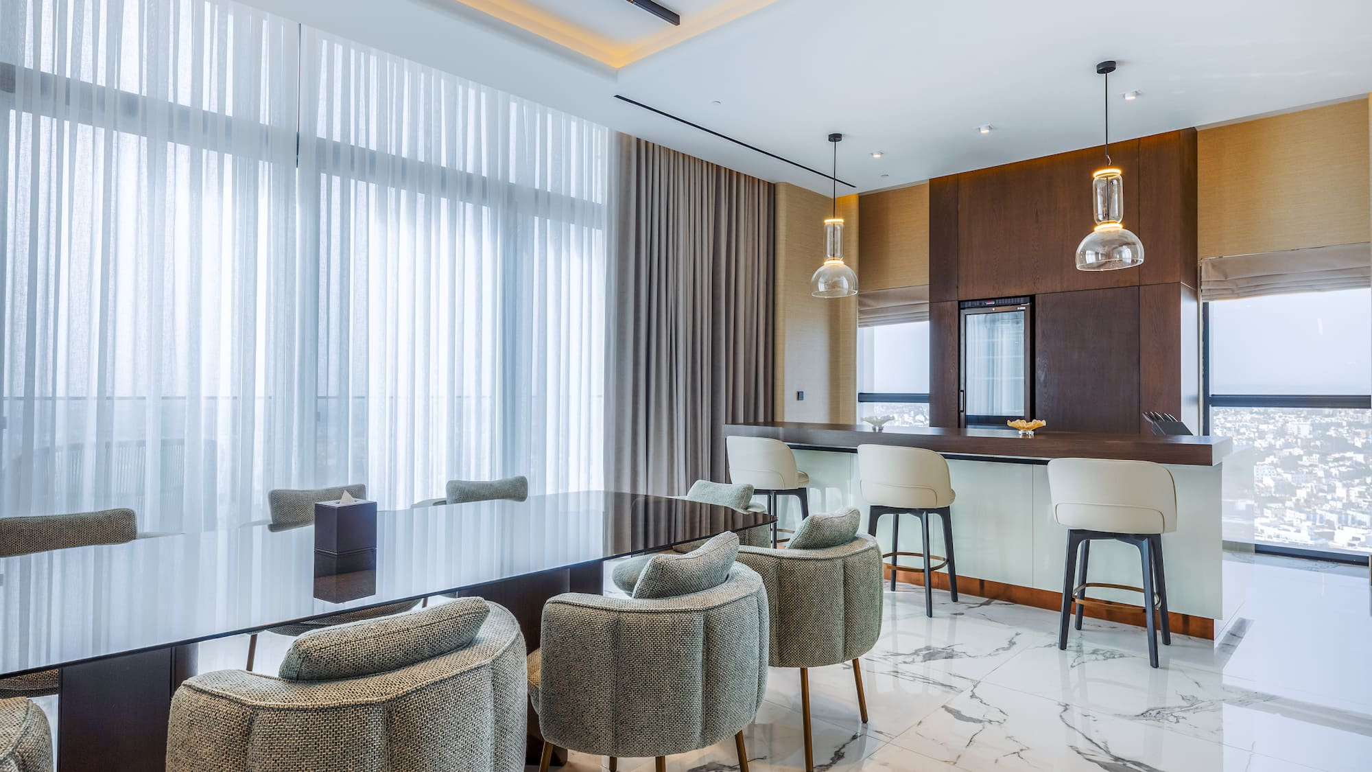 Luxury modern dining room with bar, dark table, stylish chairs, and city view.