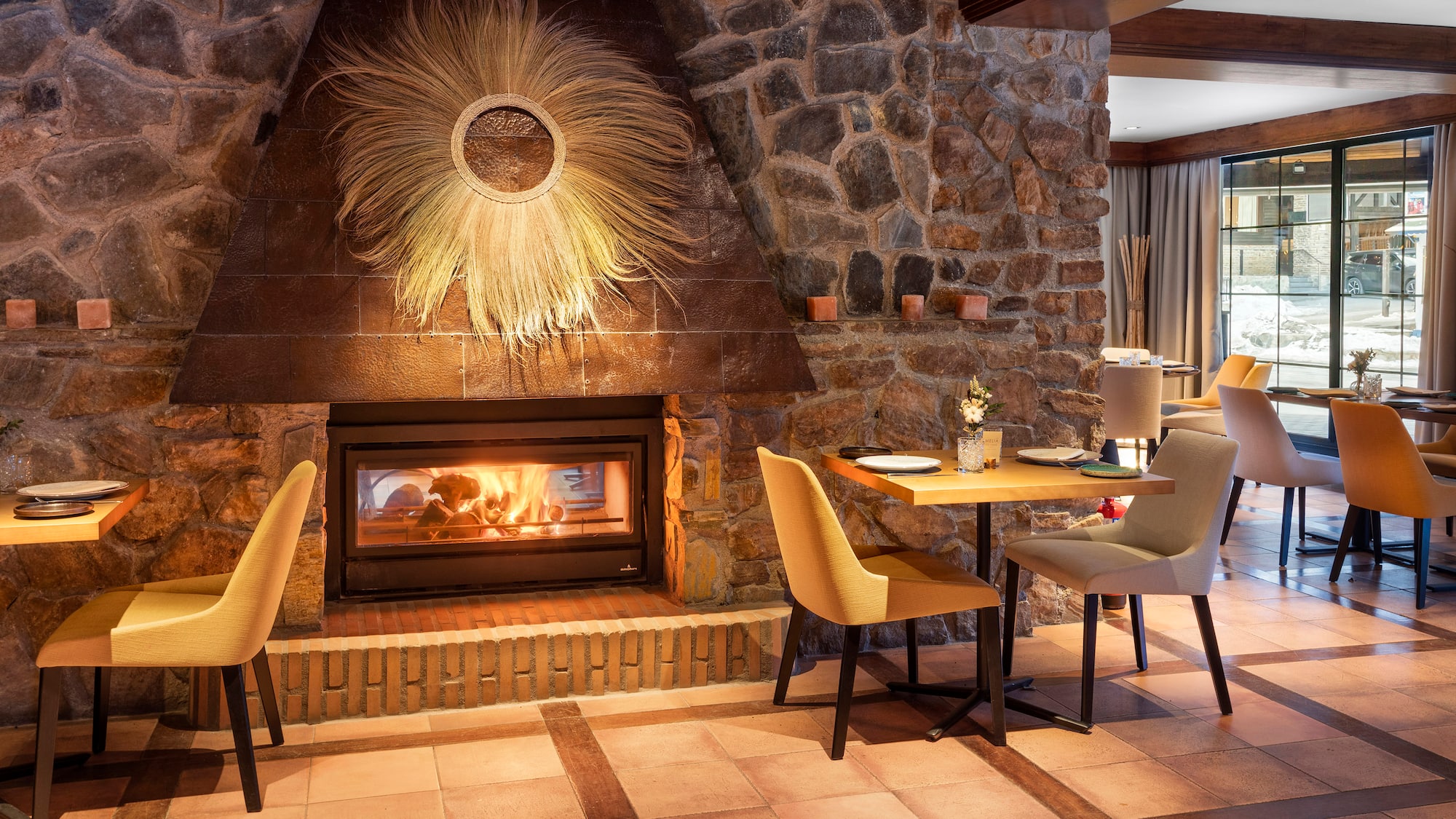 a room with a fireplace and a table and chairs