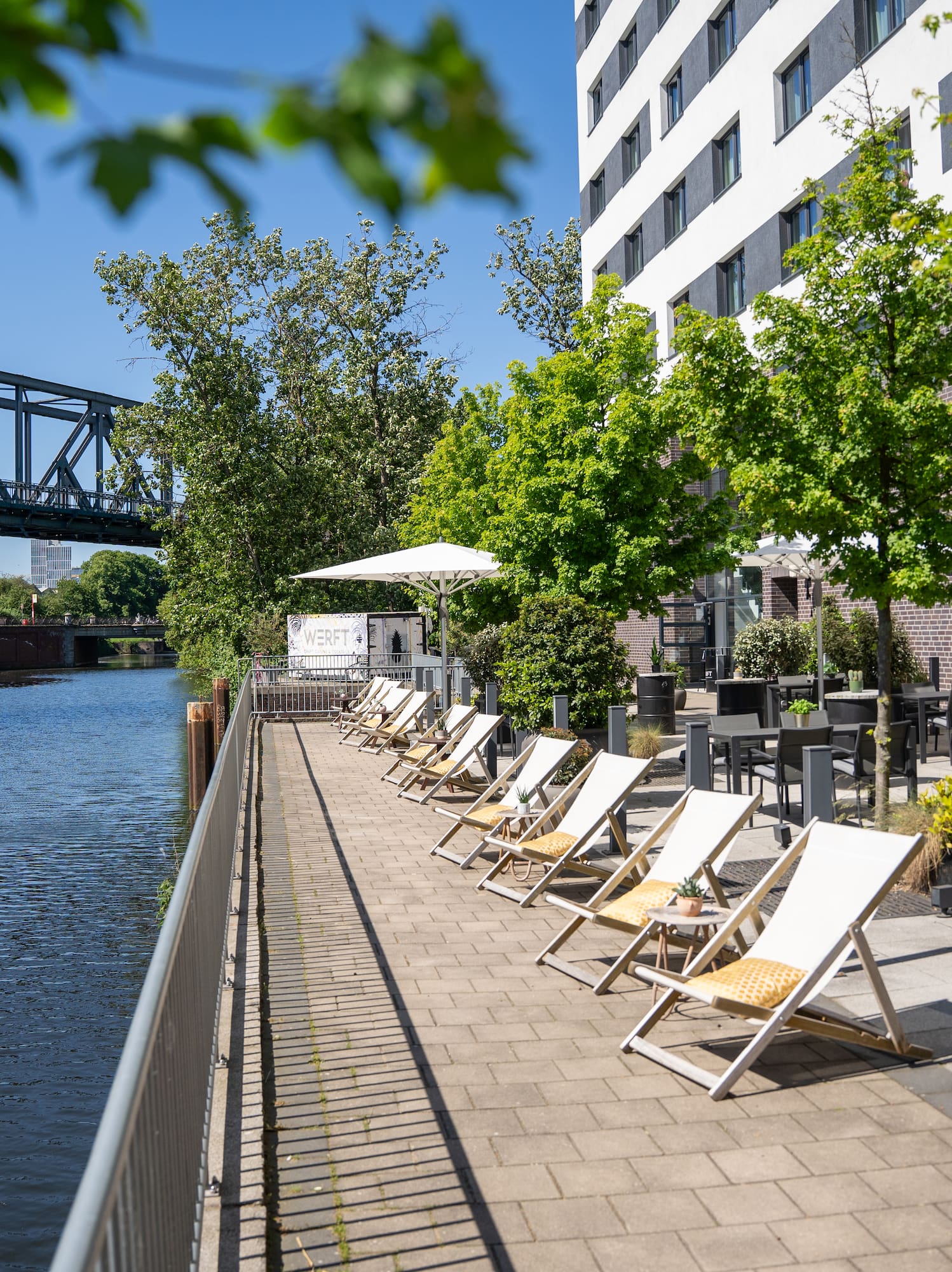 a row of chairs next to a body of water
