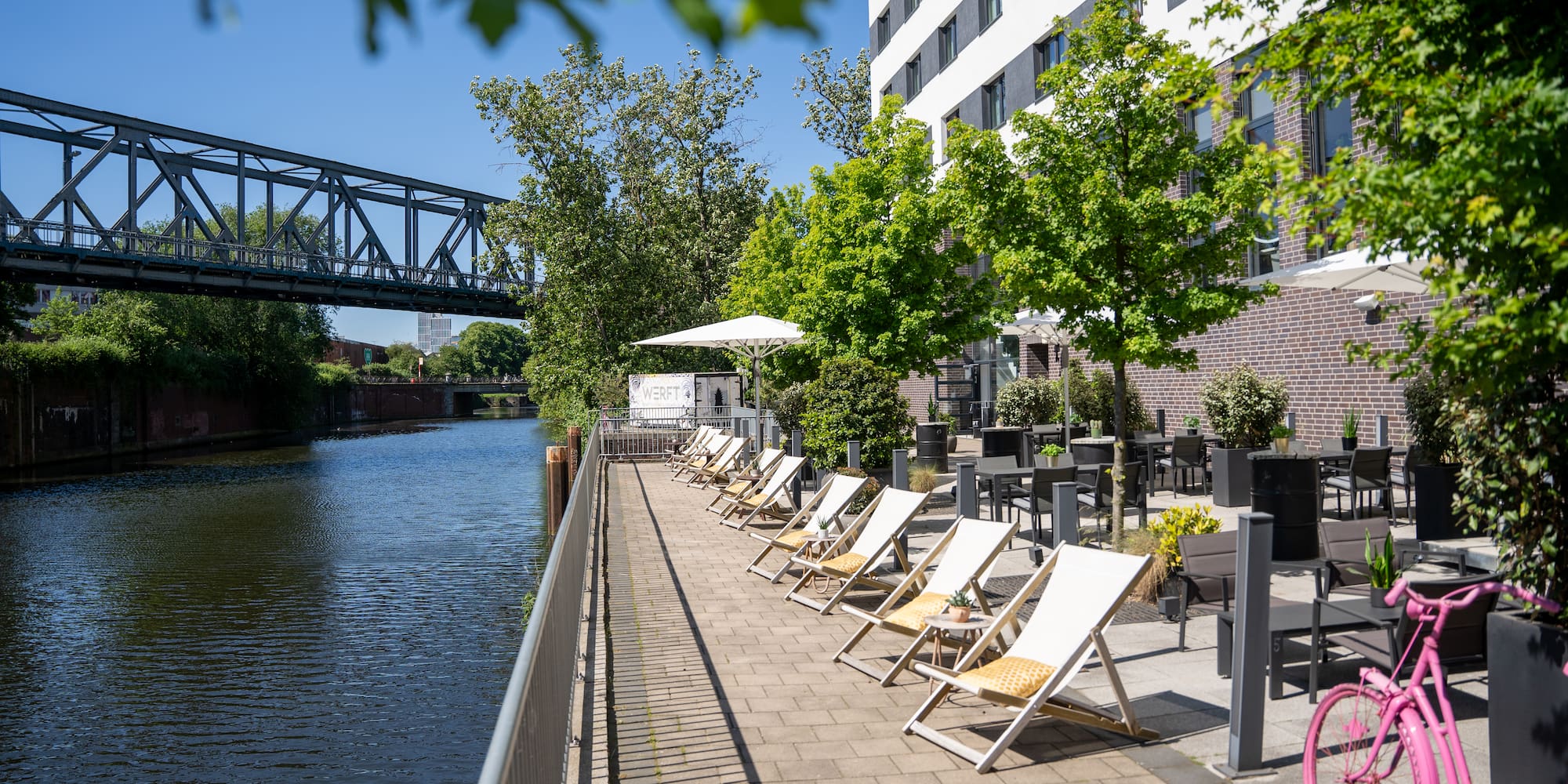 a row of chairs next to a body of water