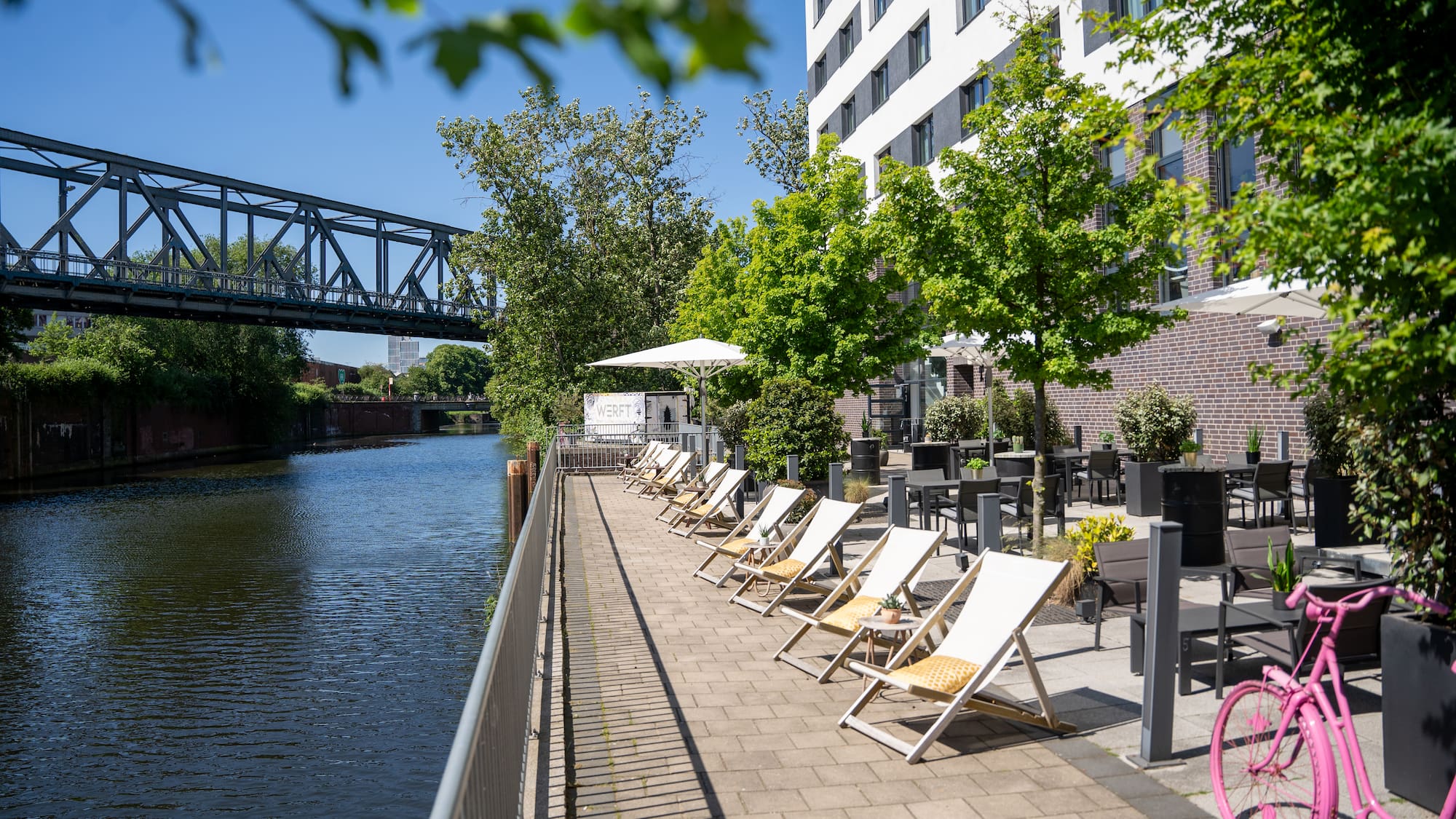 a row of chairs next to a body of water