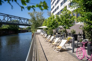 a row of chairs next to a body of water