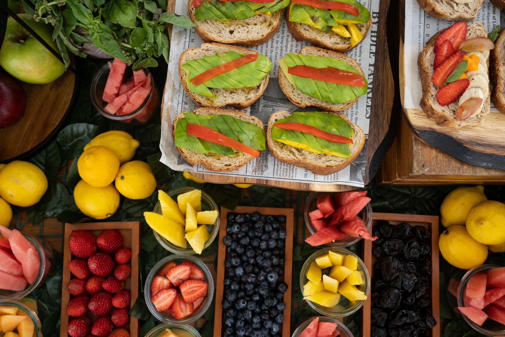 a table with different fruits and sandwiches