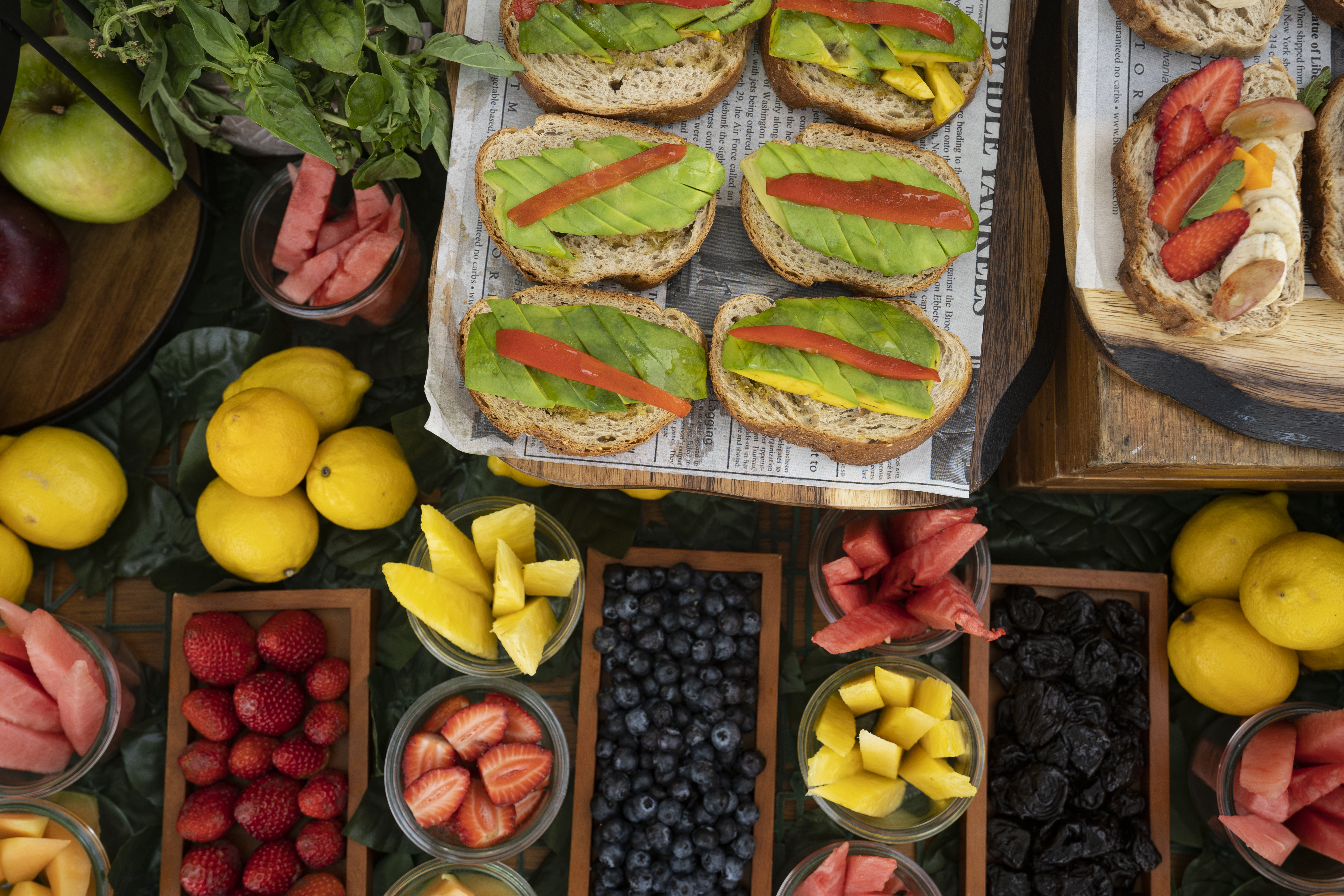 a table with different fruits and sandwiches