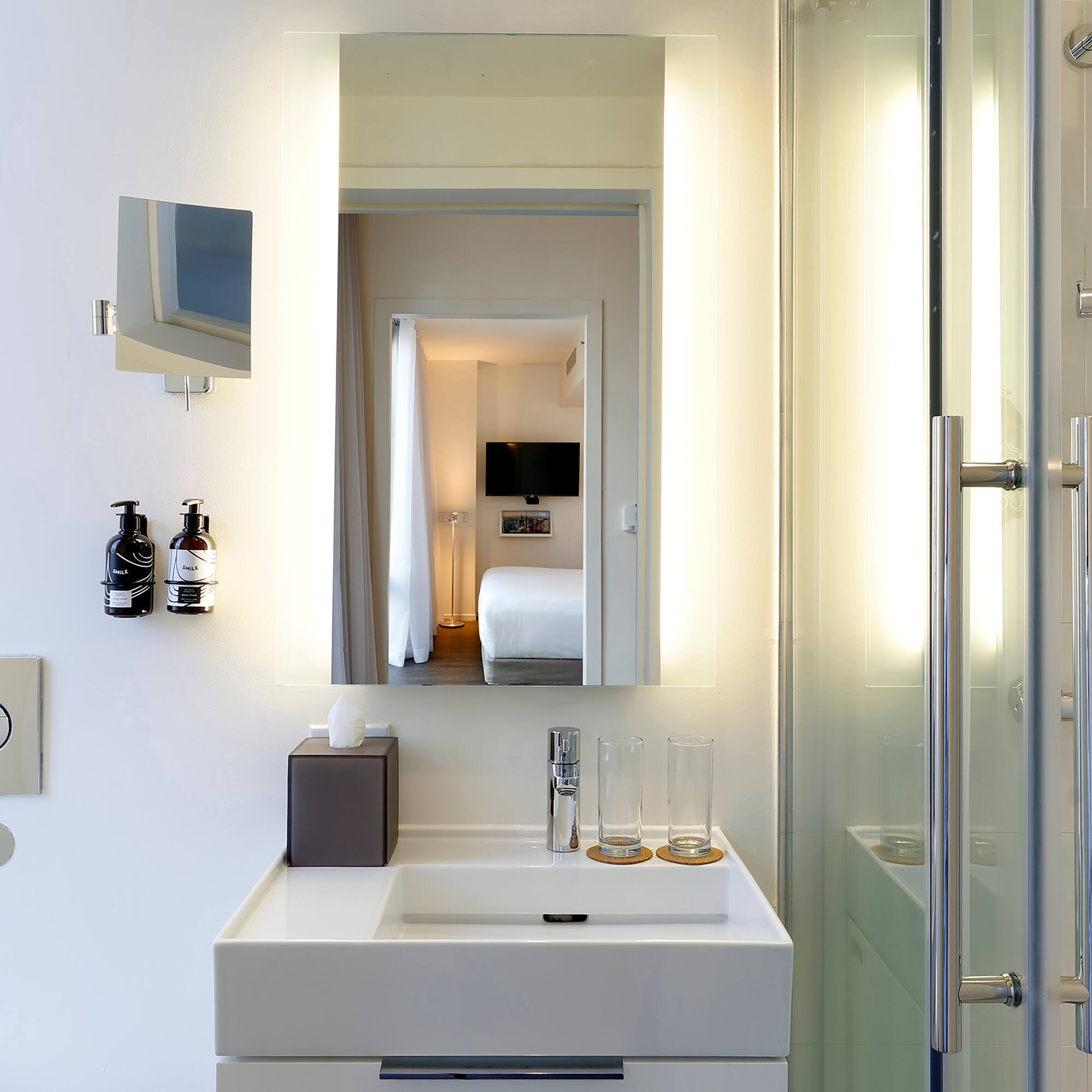 a bathroom with a mirror and a sink