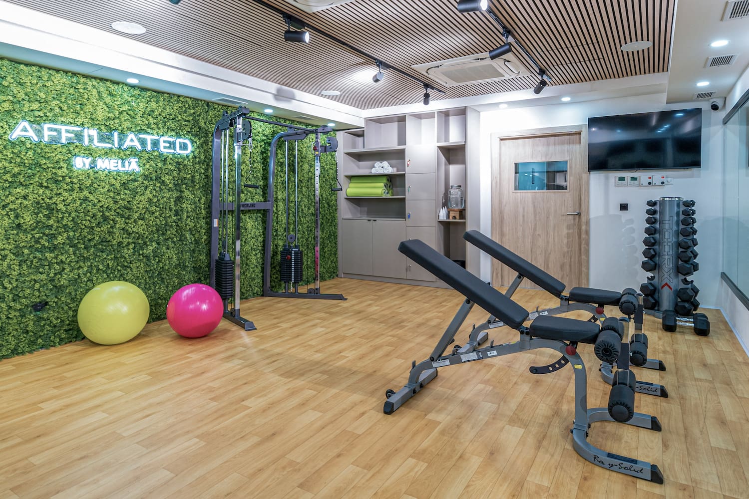 a gym with exercise equipment and exercise balls