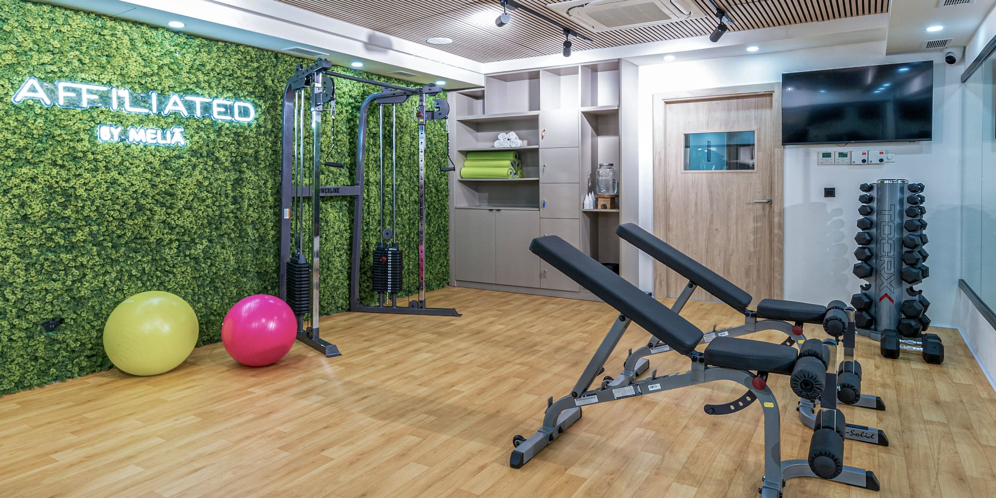 a gym with exercise equipment and exercise balls