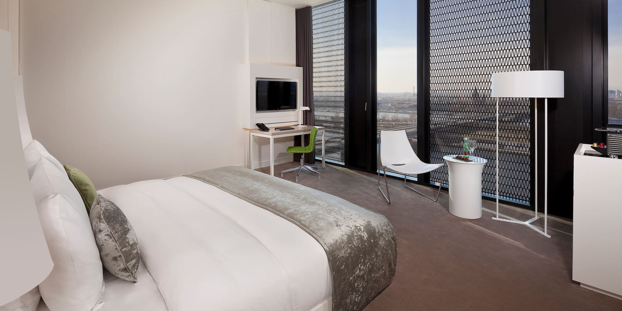 a bedroom with a bed and a desk and chair