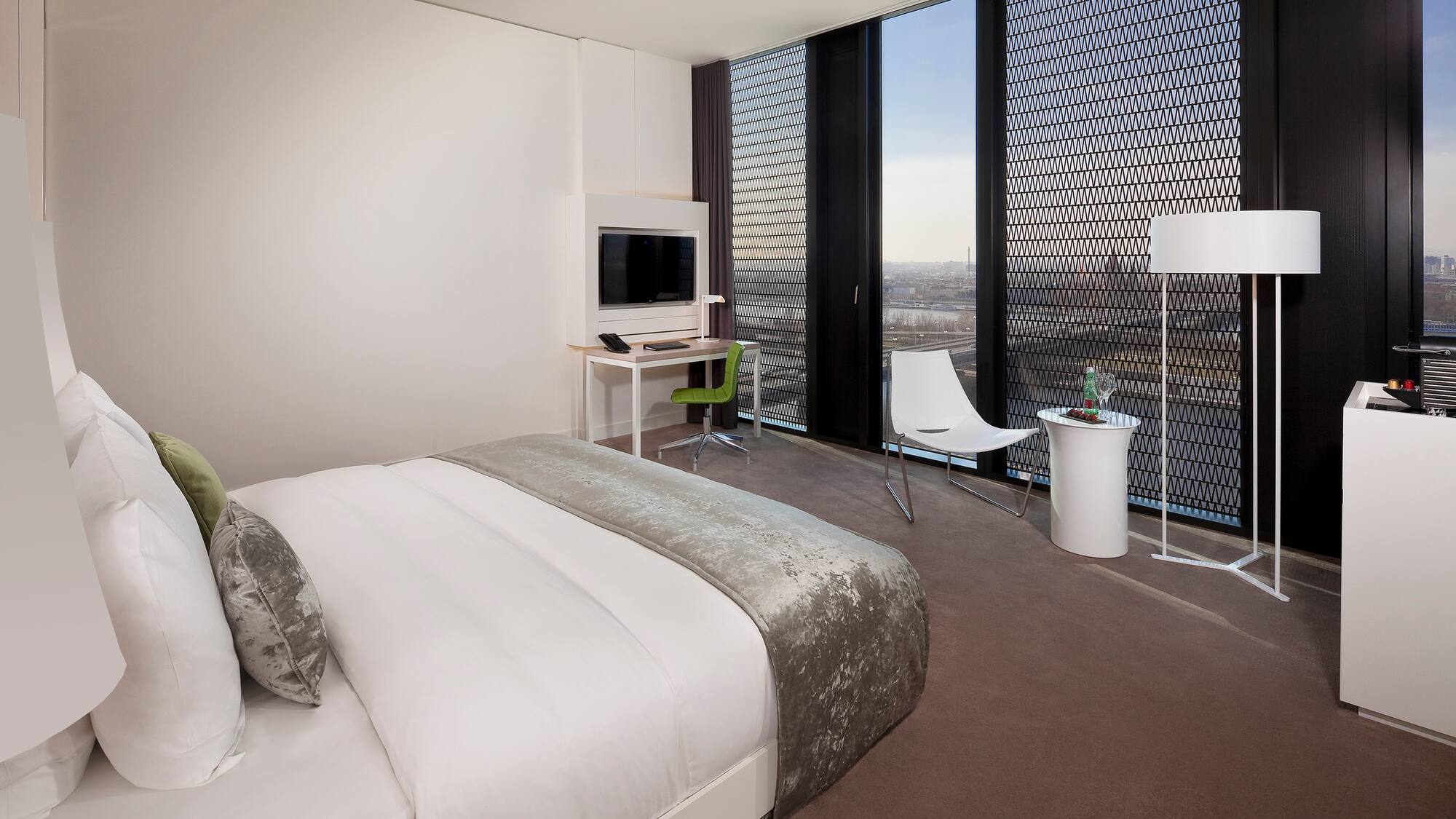 a bedroom with a bed and a desk and chair