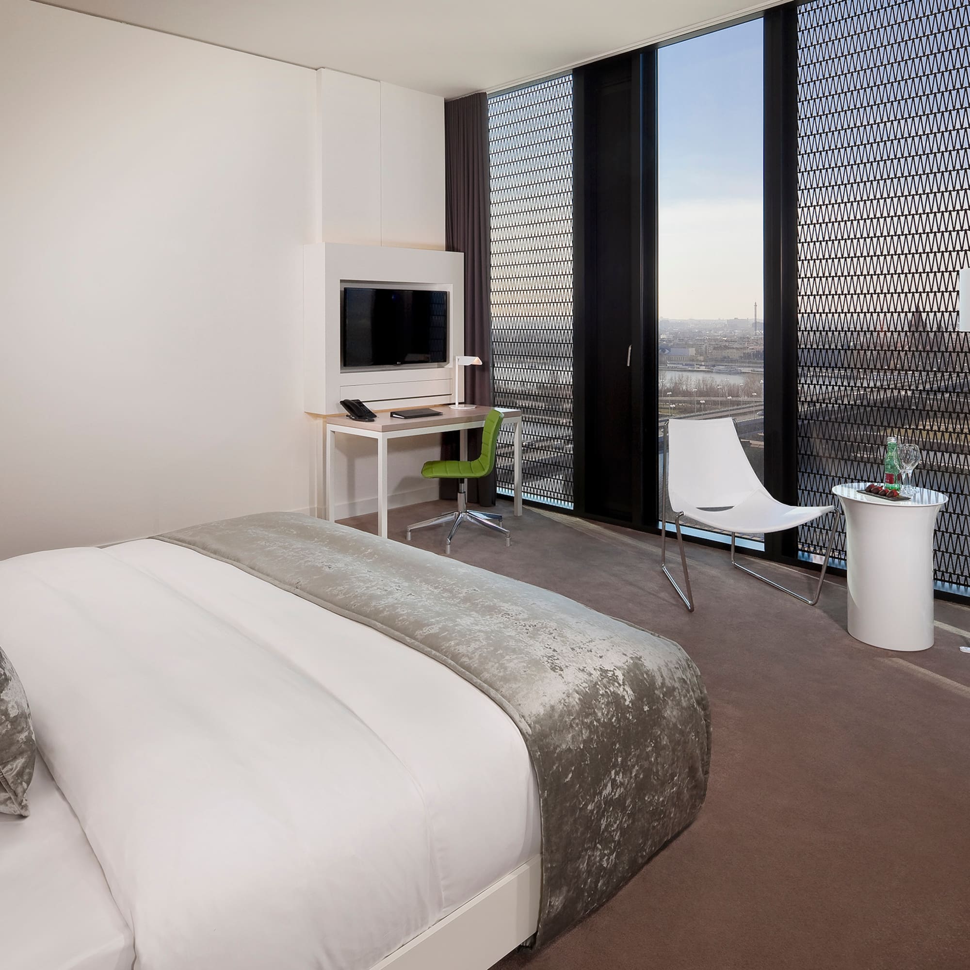 a bedroom with a bed and a desk and chair