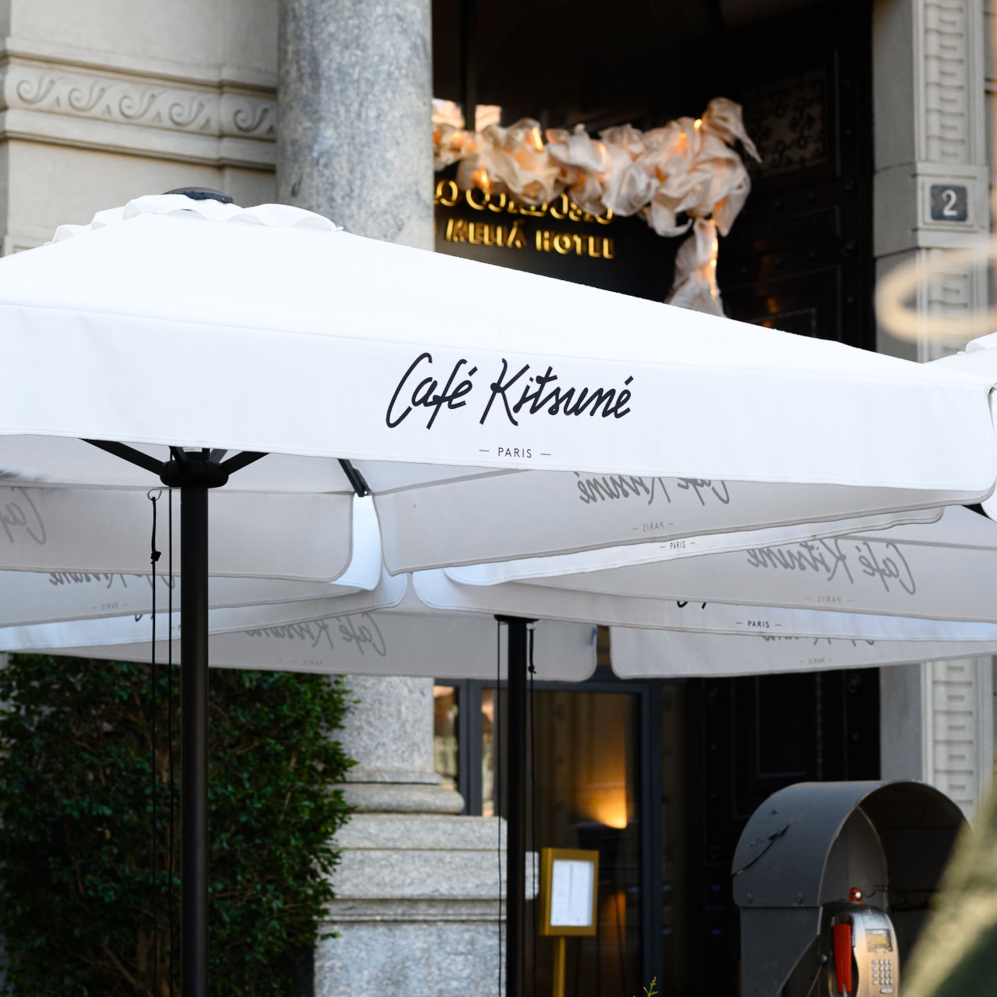 a group of white umbrellas outside of a building