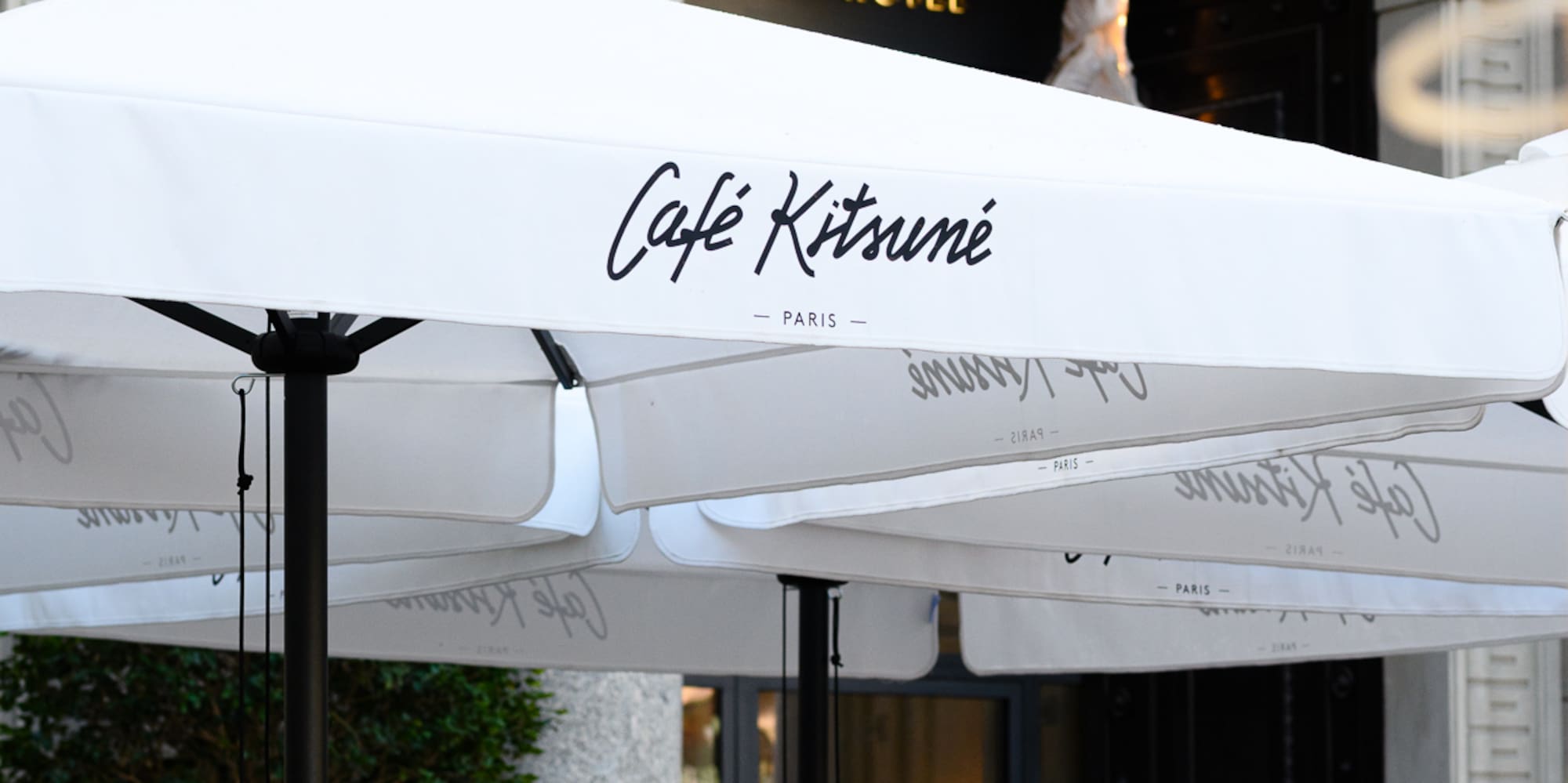 a group of white umbrellas outside of a building