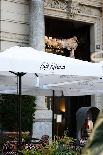 a group of white umbrellas outside of a building