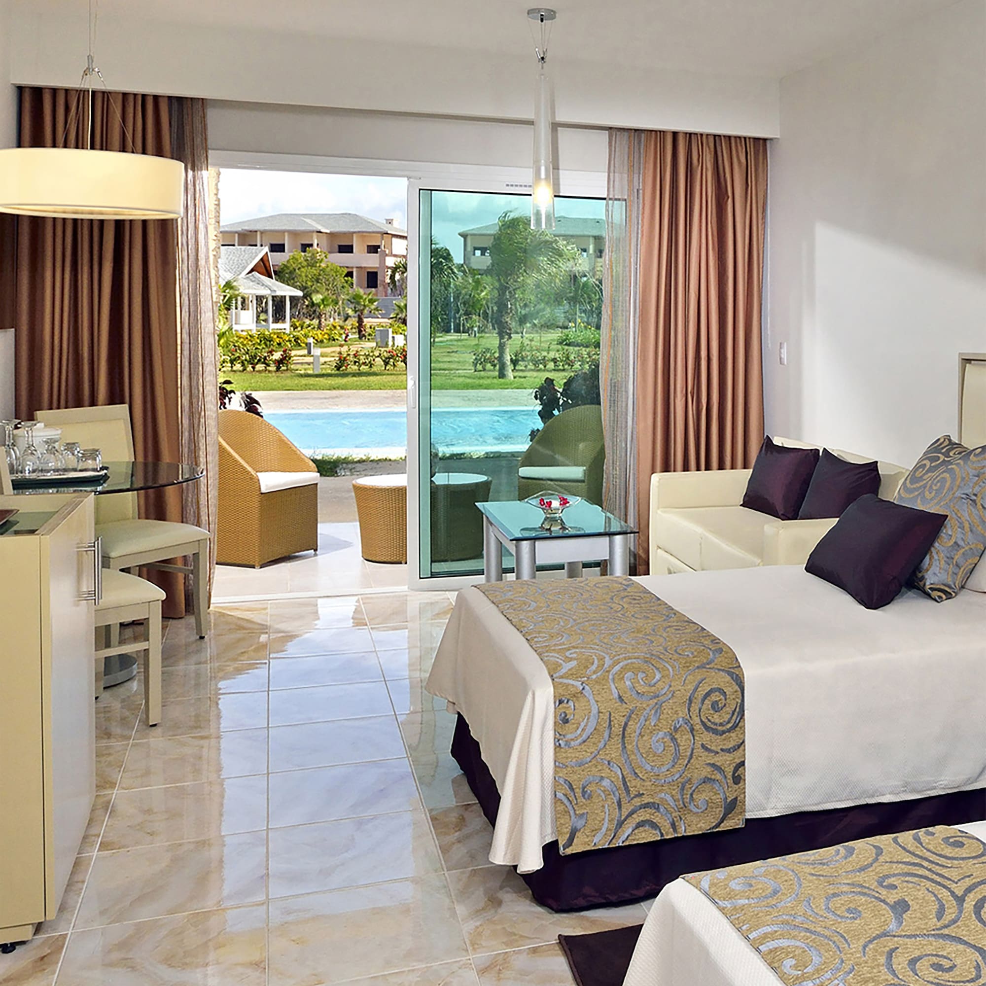 a room with two beds and a pool in the background