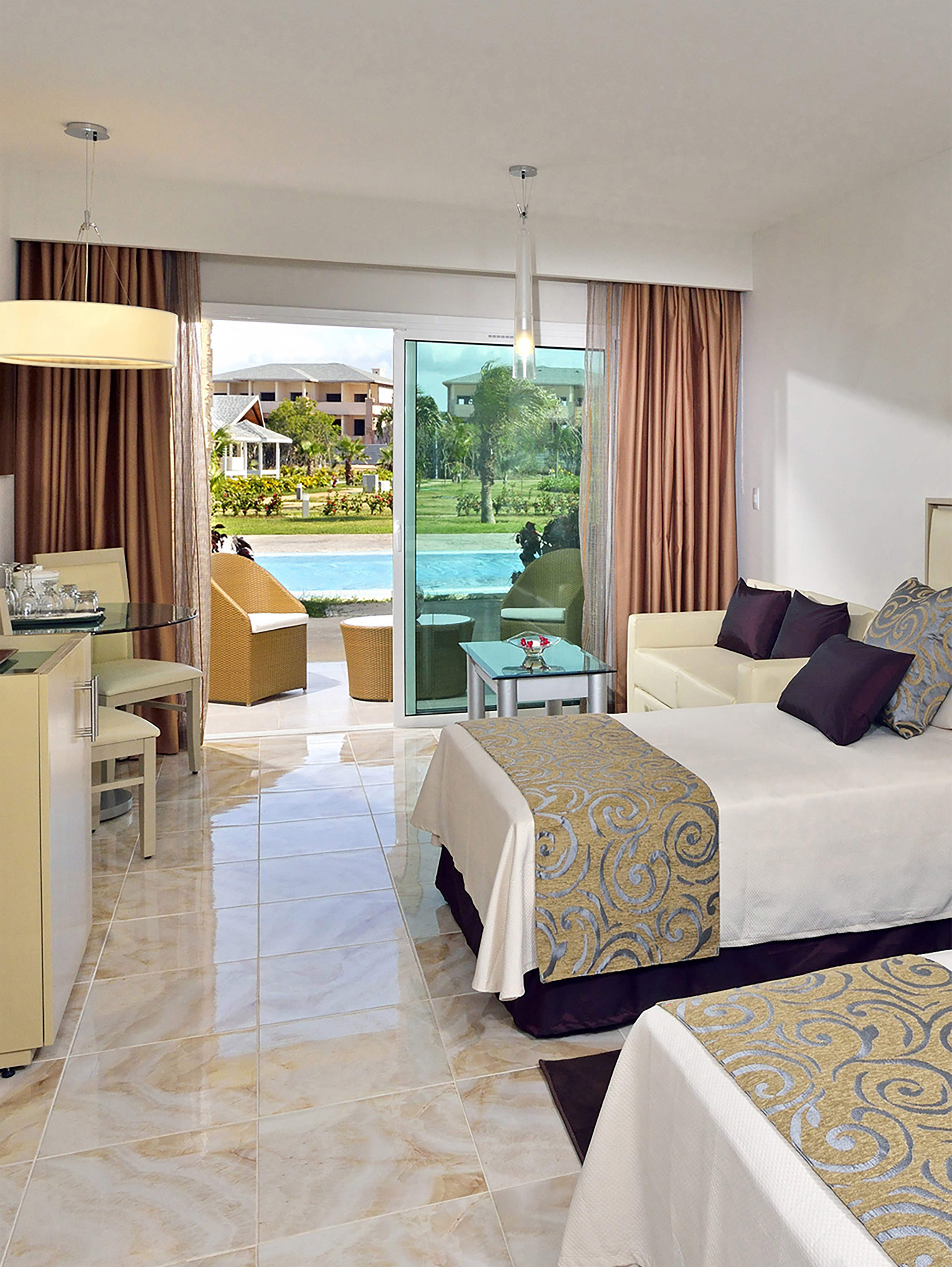 a room with two beds and a pool in the background