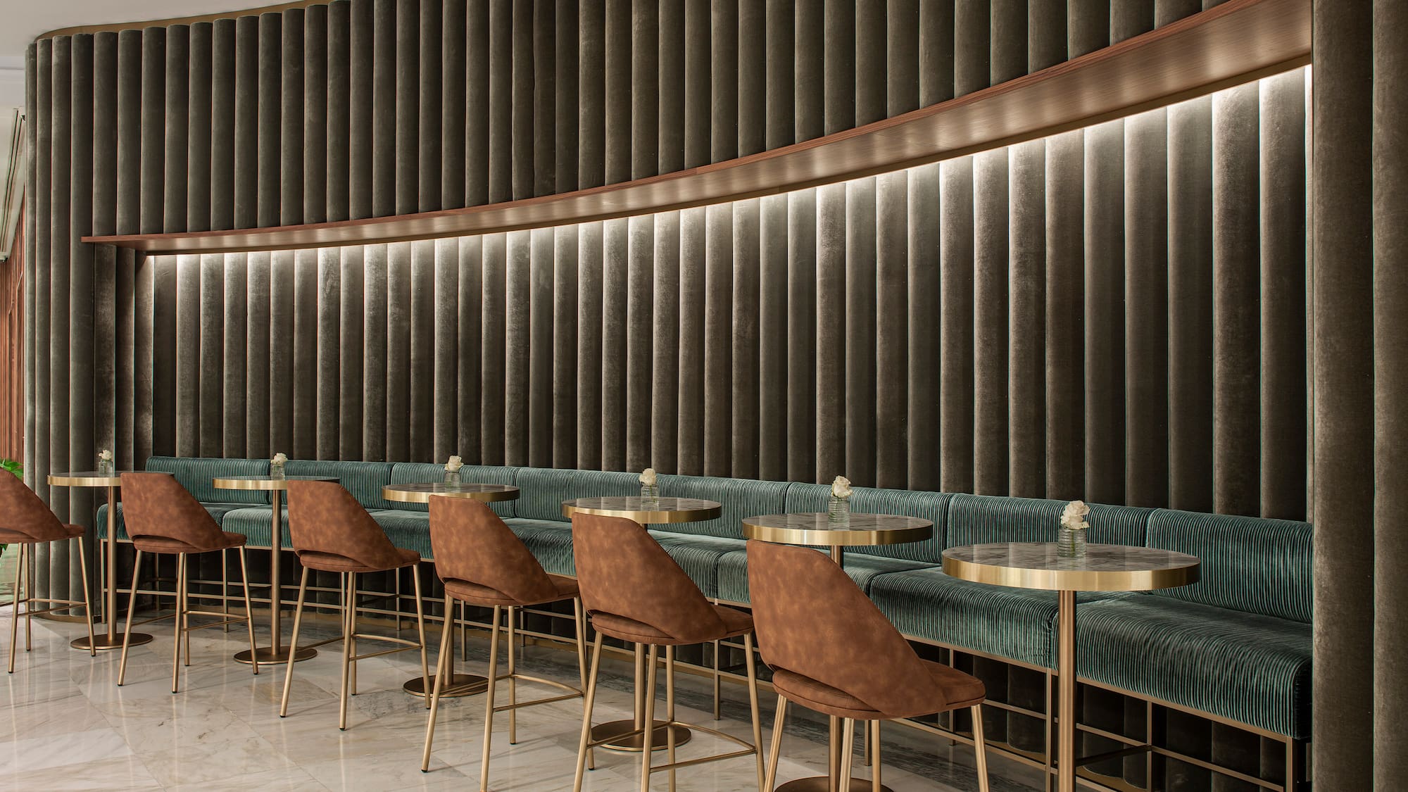 a room with a row of tables and chairs