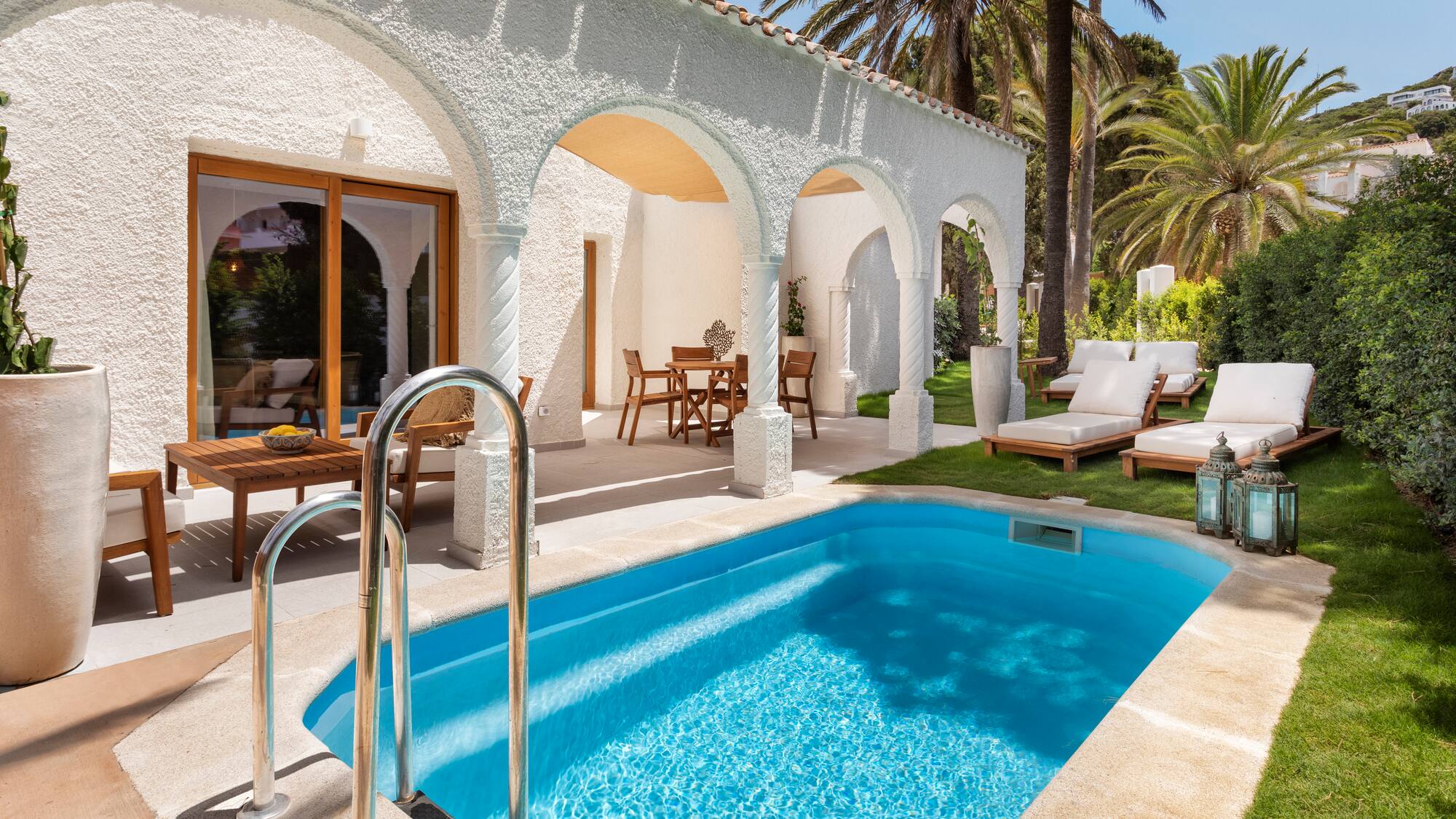 a swimming pool and lounge chairs in a house