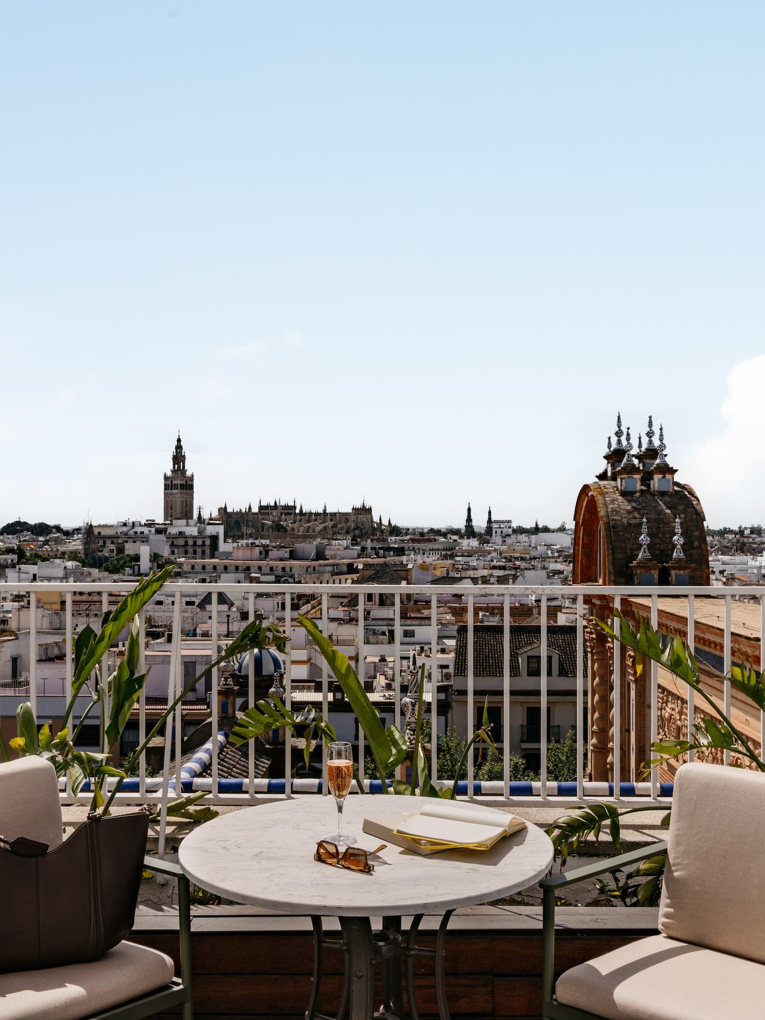 Seville rooftop terrace with Giralda tower view and outdoor lounge setup.