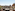 Seville rooftop terrace with Giralda tower, city view, table, chairs.