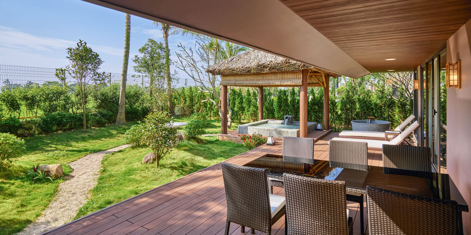 a patio with chairs and a hot tub