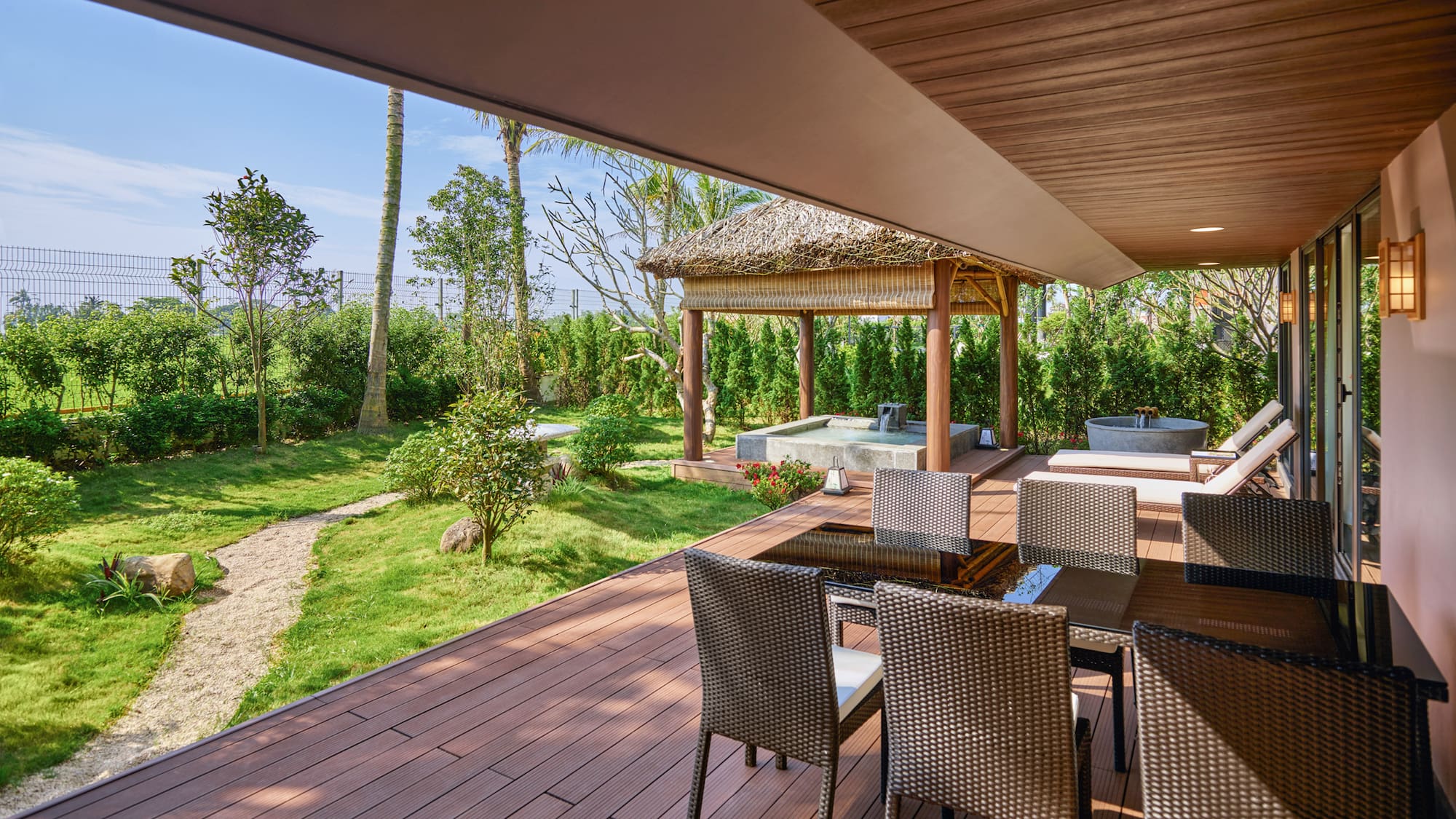 a patio with chairs and a hot tub