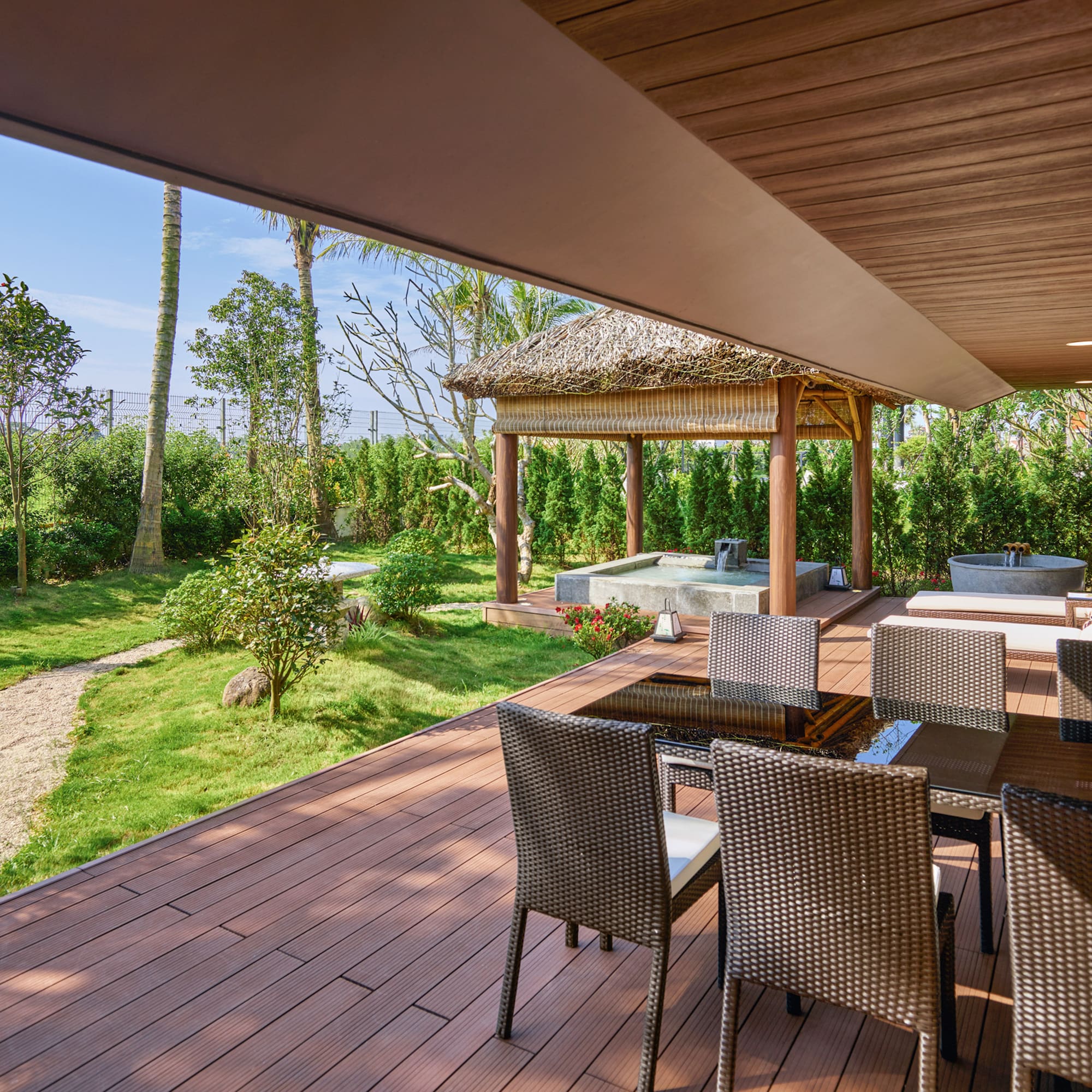 a patio with chairs and a hot tub
