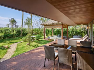 a patio with chairs and a hot tub