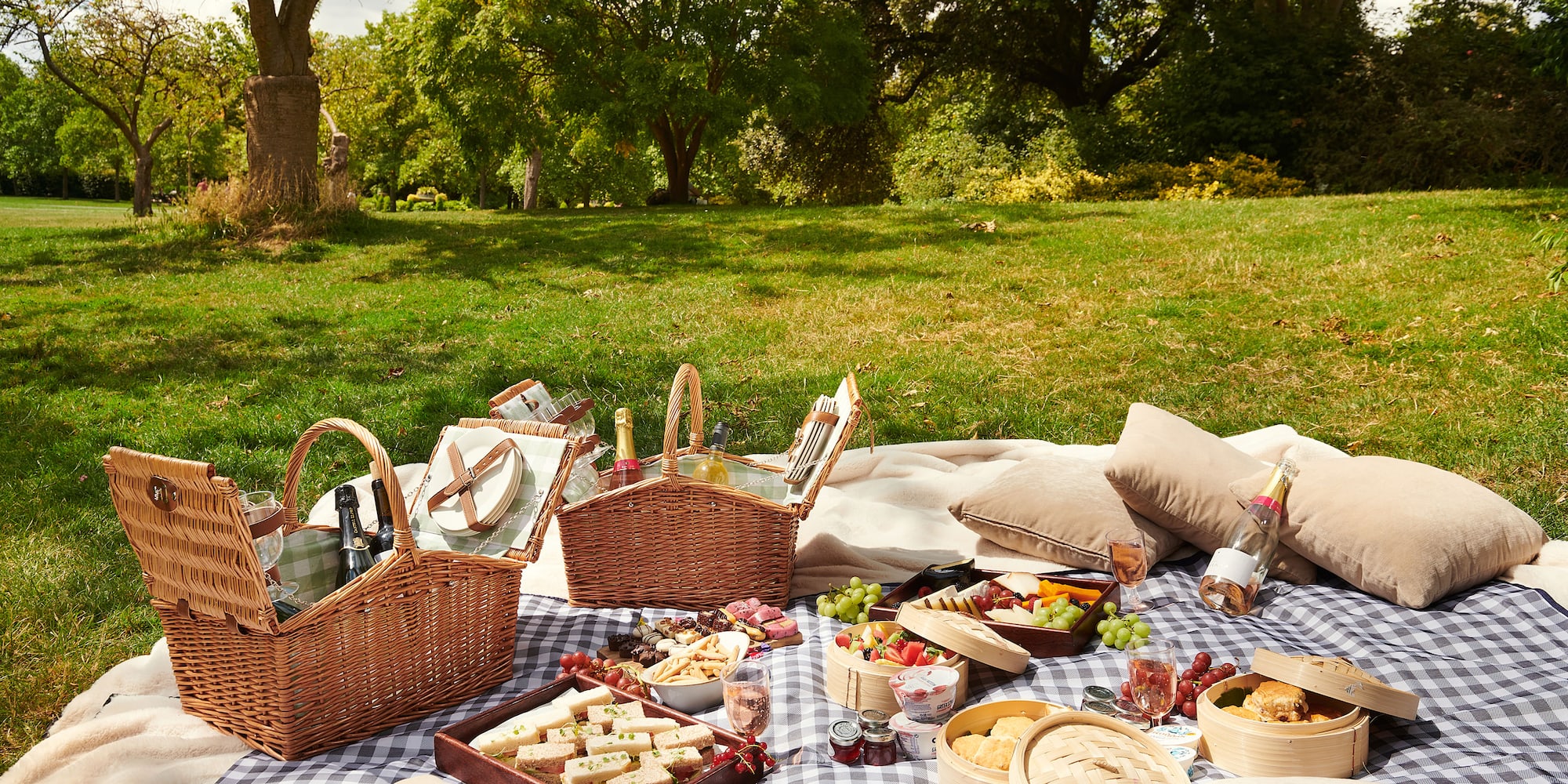 a picnic blanket with food and drinks on it
