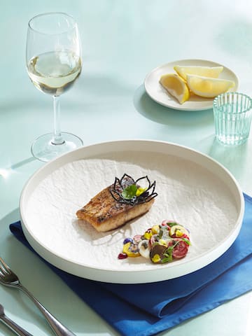 a plate of food and a glass of wine