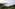 Twin golden pagodas above a sea of clouds and lush mountain forest.