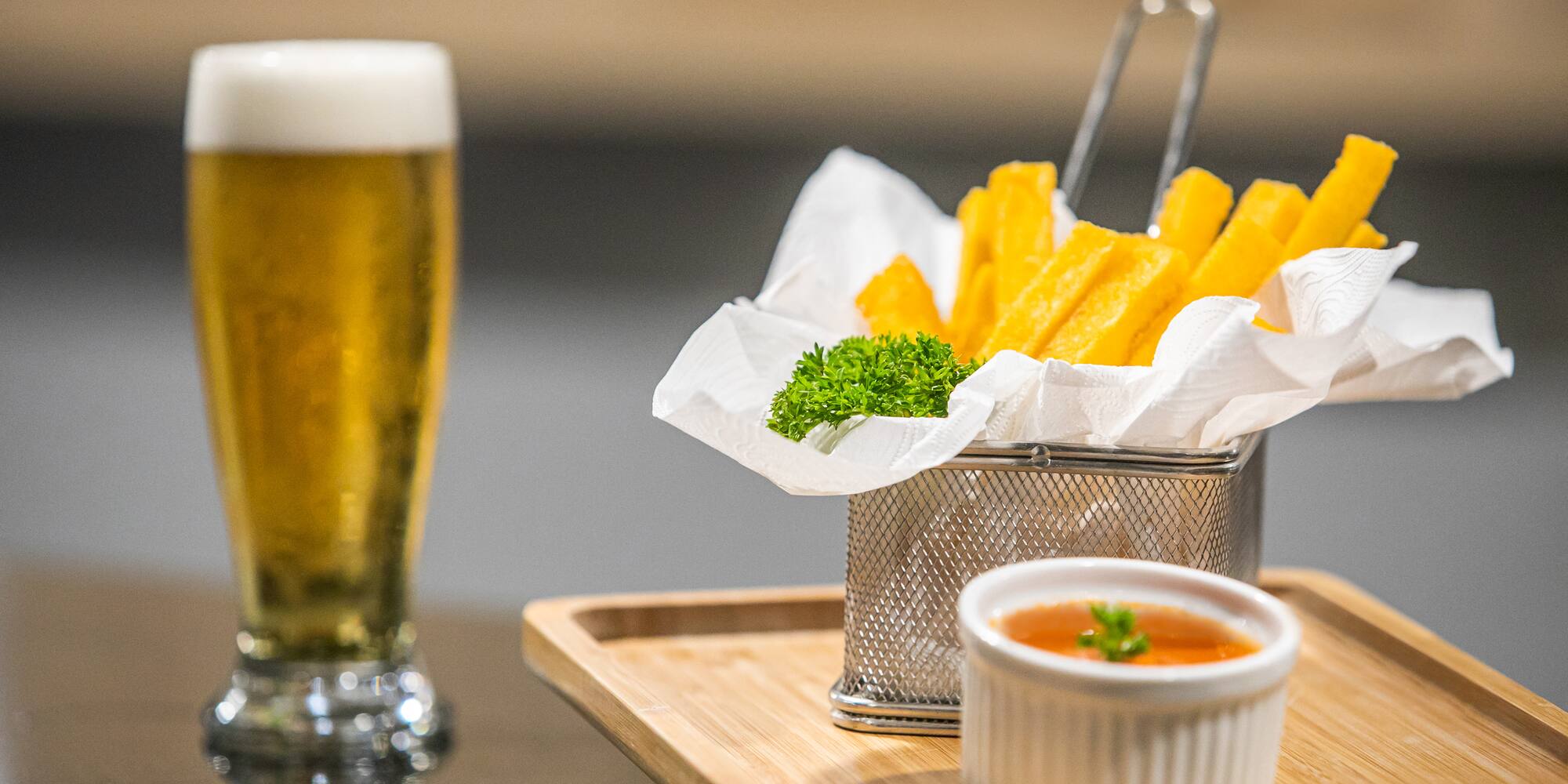 a basket of fries and sauce on a tray