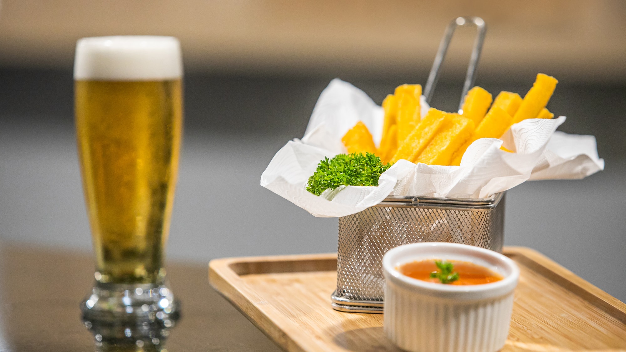a basket of fries and sauce on a tray