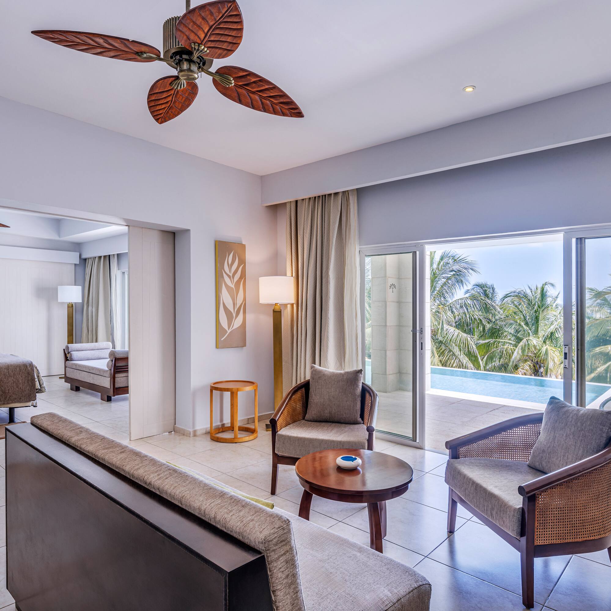 a room with a pool and a couch and chairs