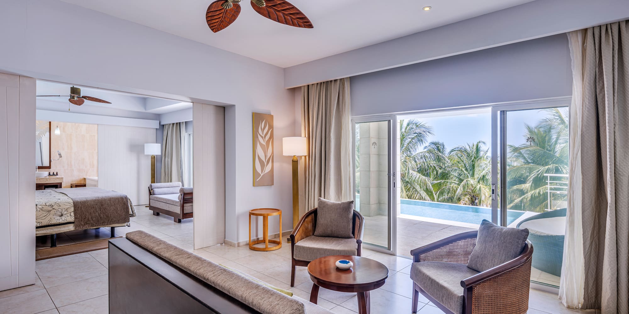 a room with a pool and a couch and chairs