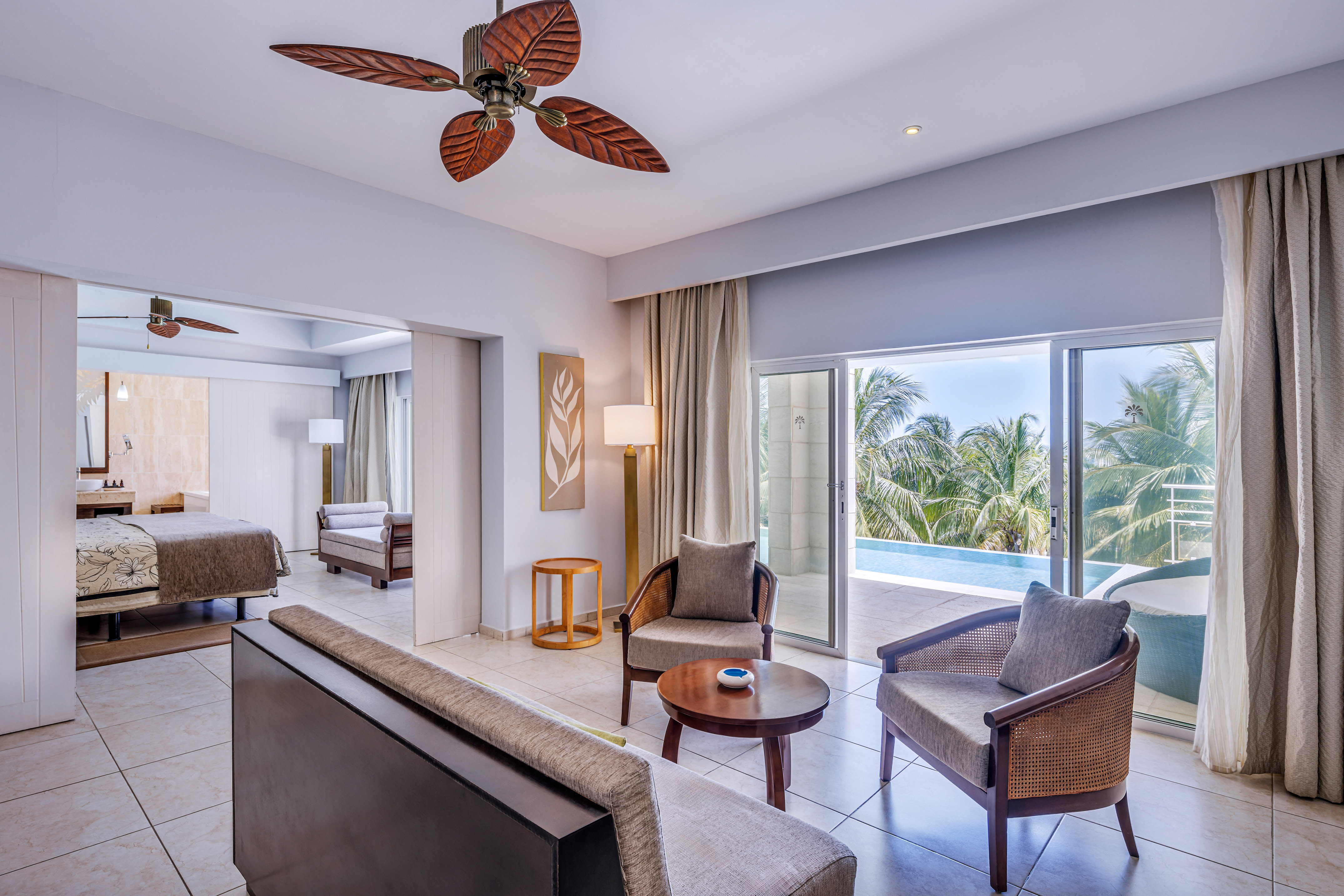 a room with a pool and a couch and chairs