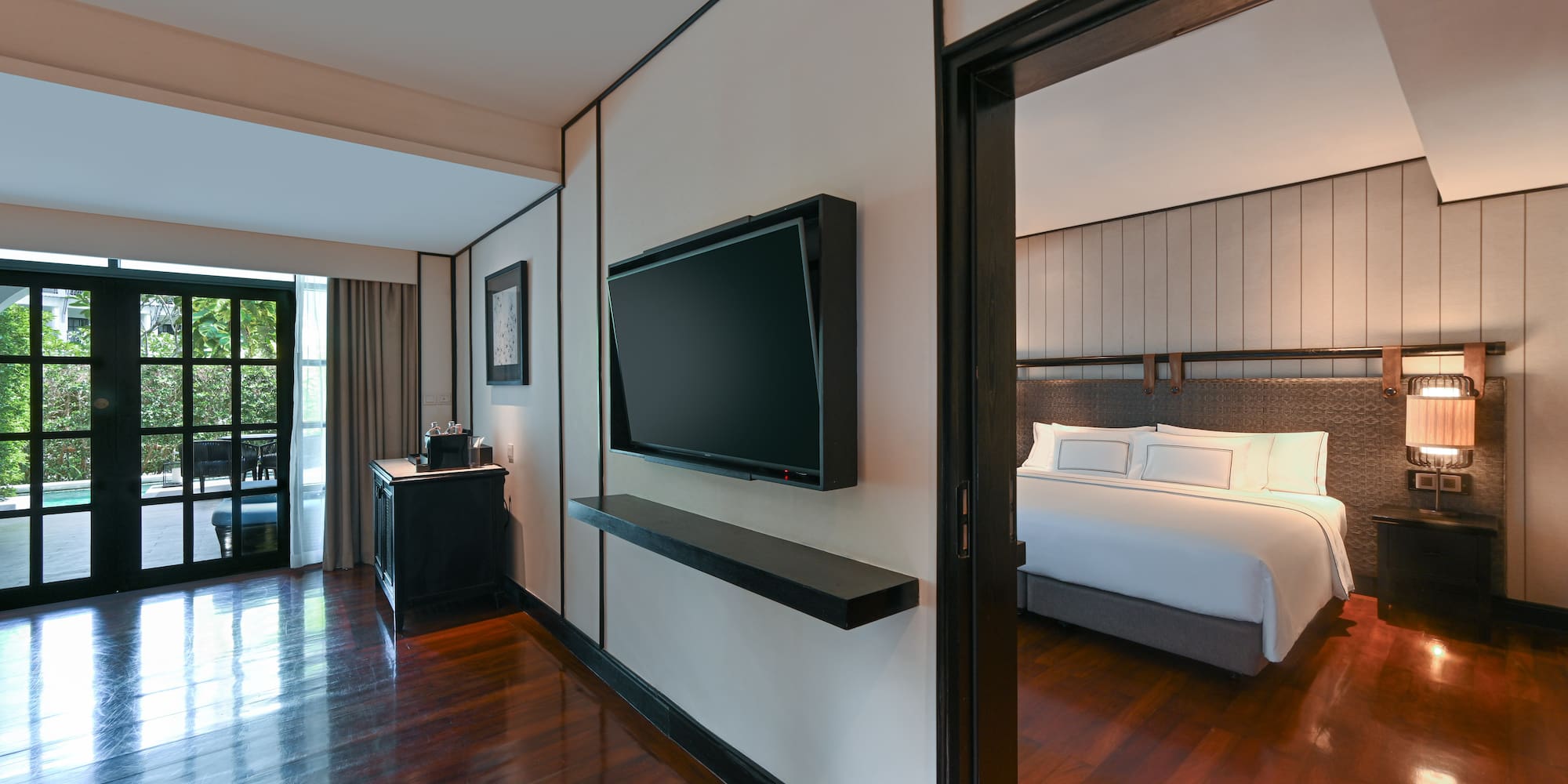 a room with a bed and a tv on the wall