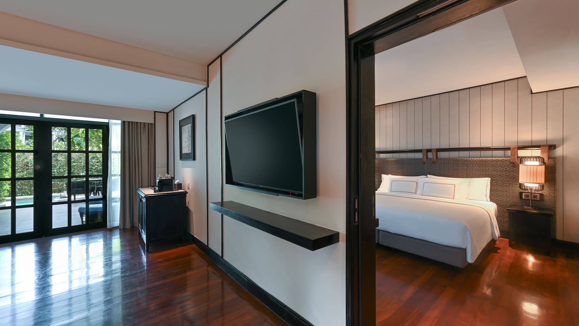 a room with a bed and a tv on the wall