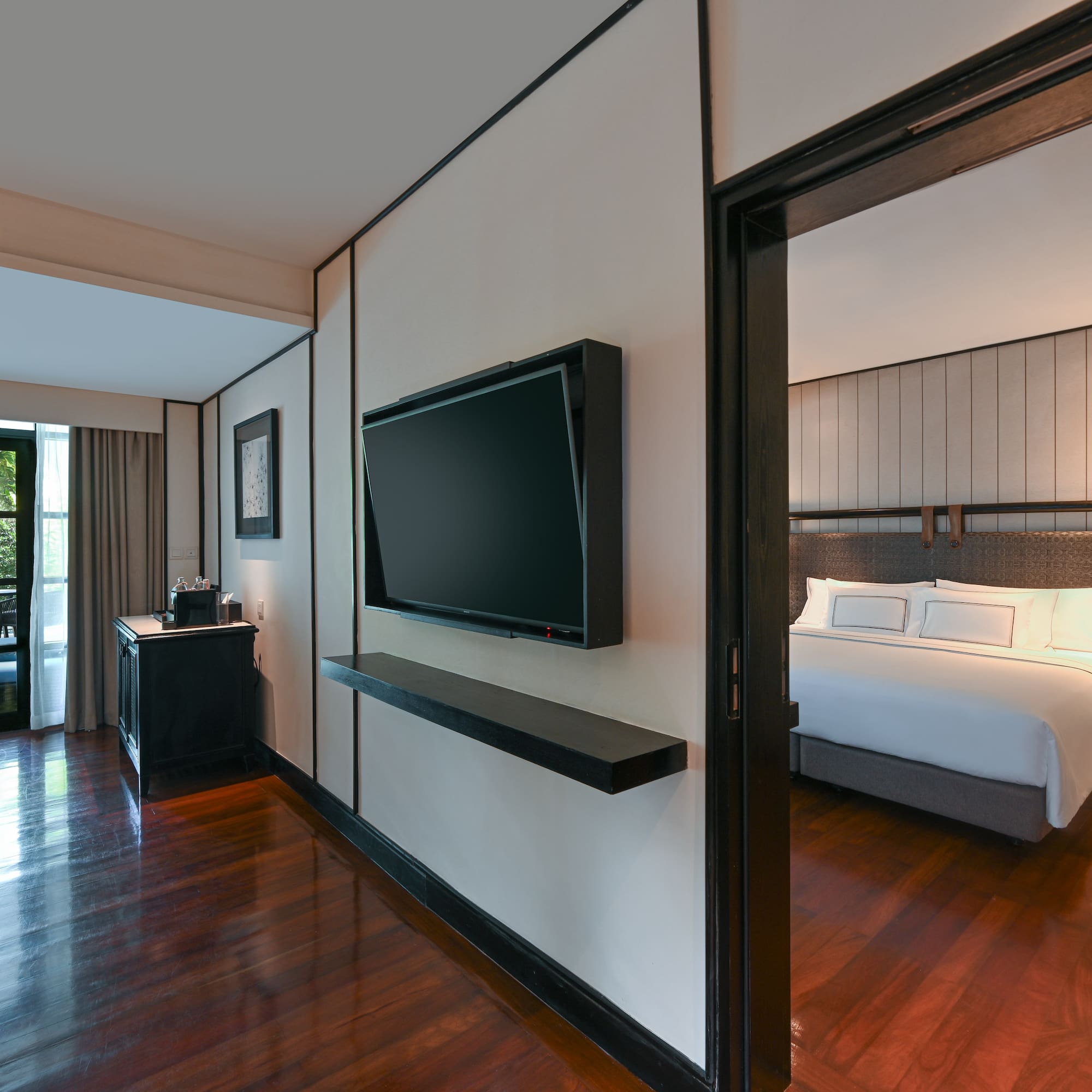 a room with a bed and a tv on the wall