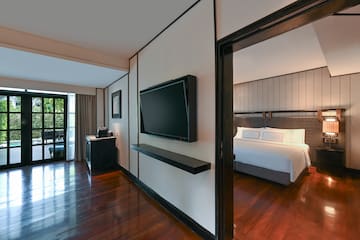 a room with a bed and a tv on the wall