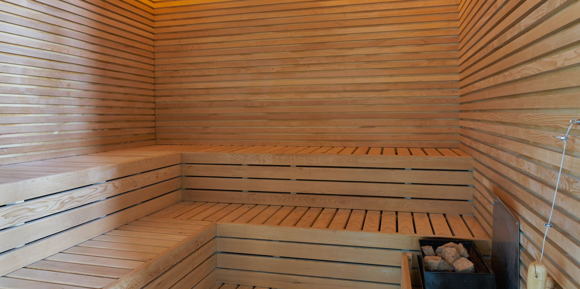 a wooden sauna with a bucket and a bucket