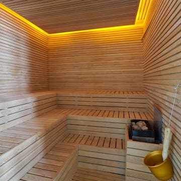 a wooden sauna with a bucket and a bucket