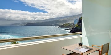 a table and chairs overlooking a body of water