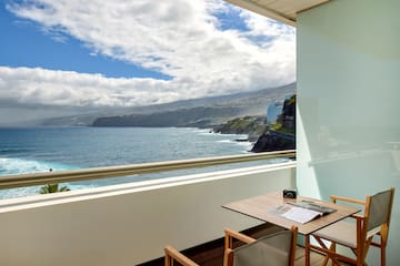 a table and chairs overlooking a body of water