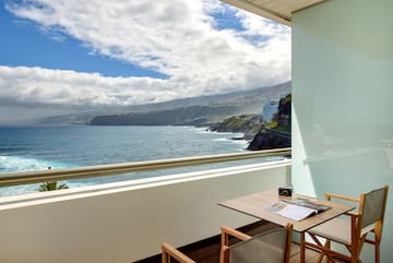 a table and chairs overlooking a body of water