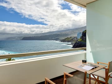 a table and chairs overlooking a body of water