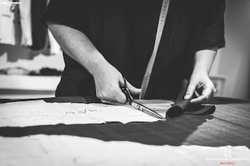 a person cutting fabric with scissors