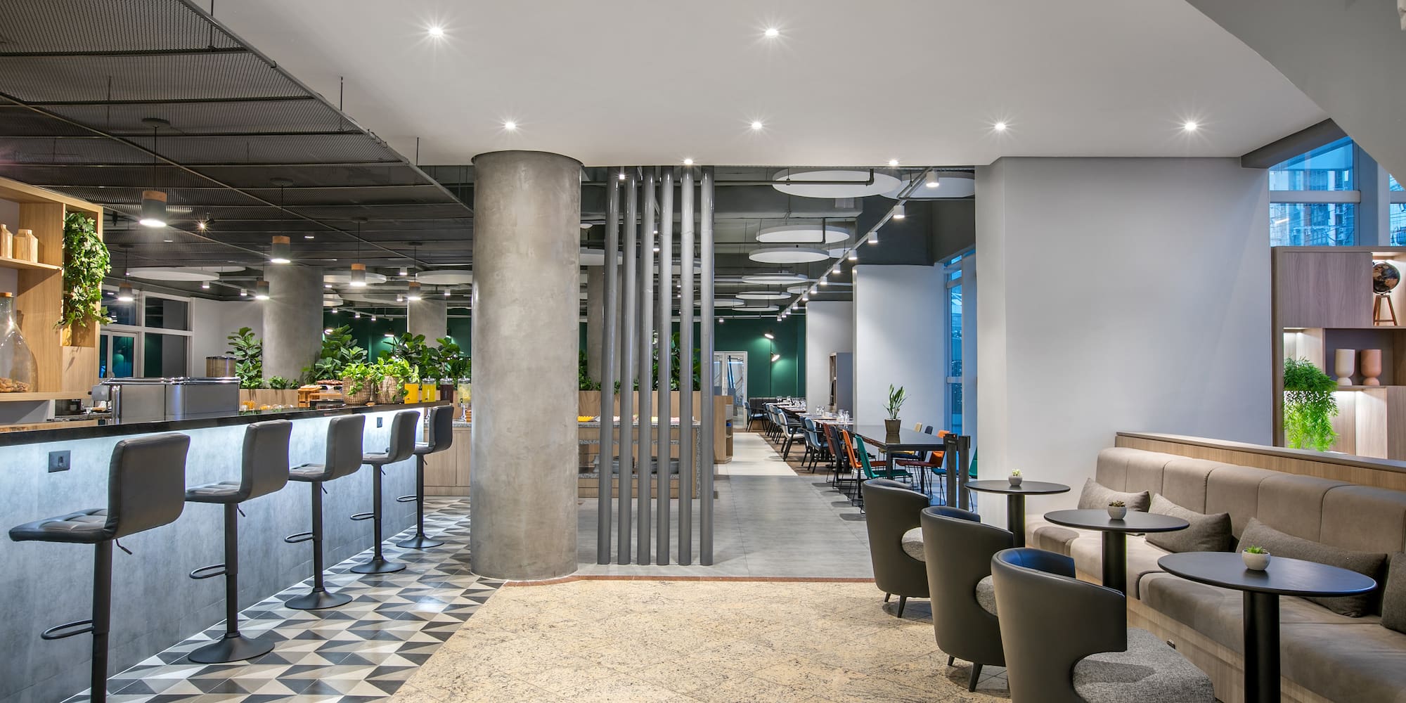 a room with a bar and chairs